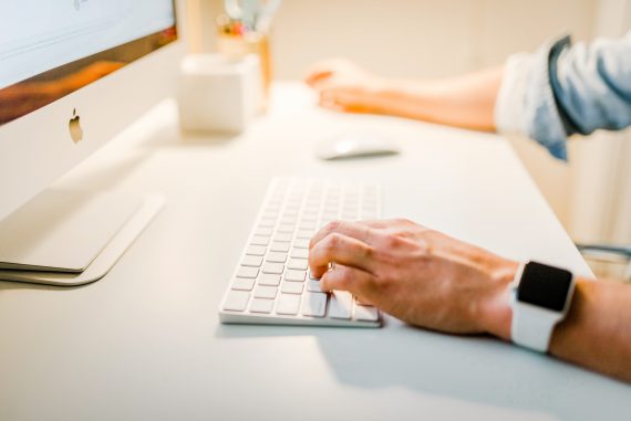 hands on computer keyboard inserting content