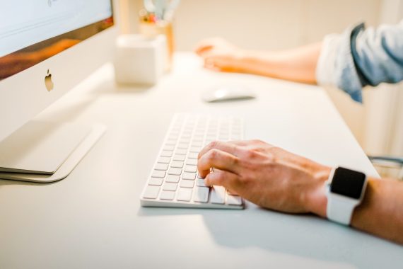 hands on computer keyboard inserting content